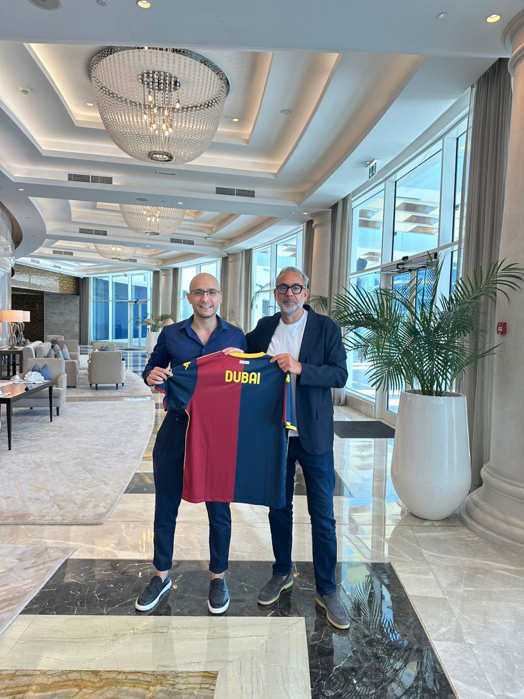 Dr. Ward Shueibi holding the Genoa Dubai jersey