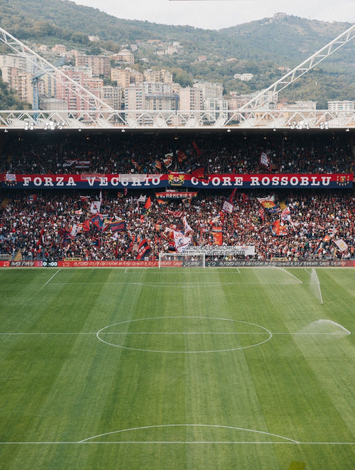 Stadio Luigi Ferraris full of Genoa supporters, the hills of Genova behind